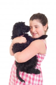 girl hugging dog